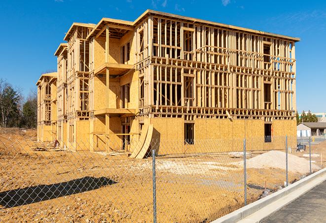 a close-up of temporary chain link fences enclosing a job site, signaling progress in the project's development in Eggertsville NY